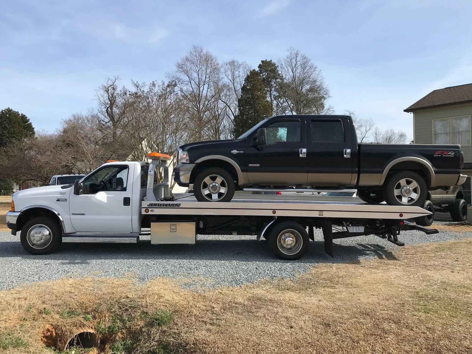 Black Ford FX4 crew cab loaded on the Capital Towing rollback
